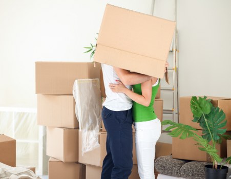 Mover wearing PPE while handling furniture during a relocation